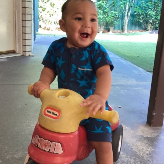 Toddler riding a toy bike - Seedlings Early Learning and Childcare