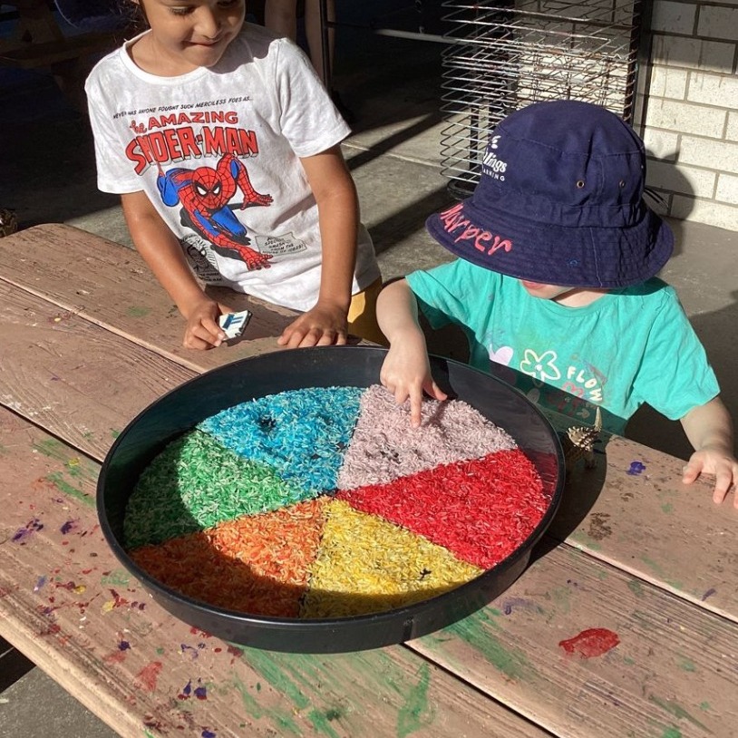 Two kids playing with coloured grains - Seedlings Early Learning and Childcare