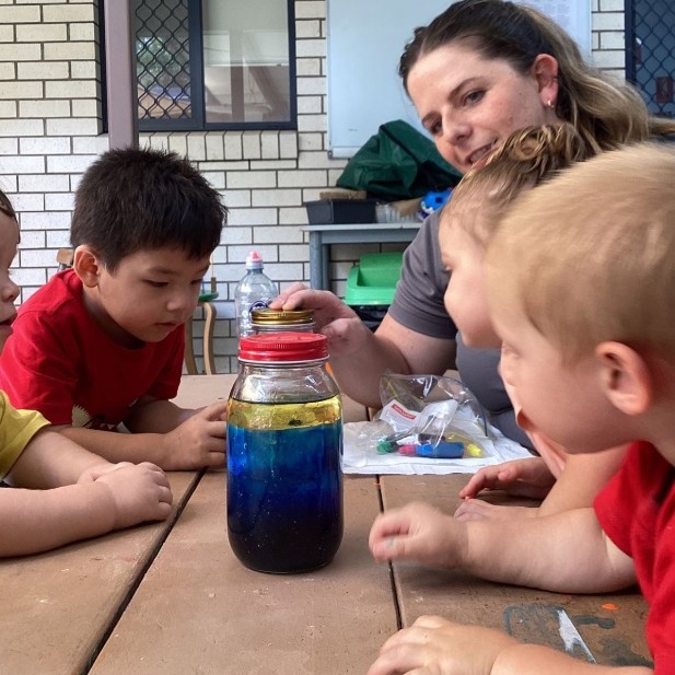 Children and teacher with jar of paint - Seedlings Early Learning and Childcare